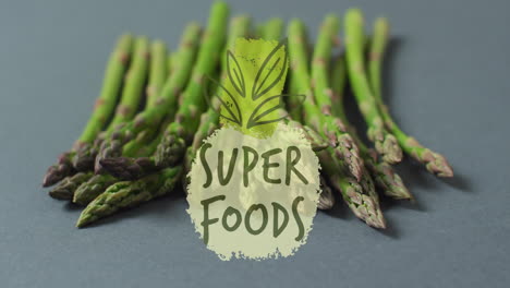 asparagus spears with super foods text and leaf animation over them