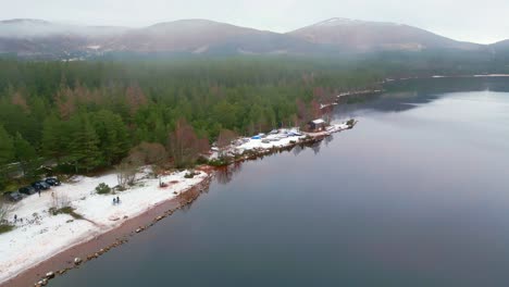 sail boats on trailers covered during the cold winter weather on banks of lake