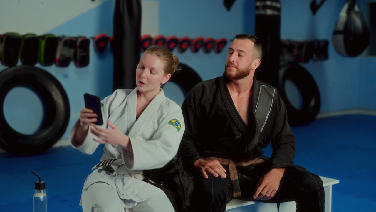 BJJ athletes taking a selfie and interacting during a training break in the gym