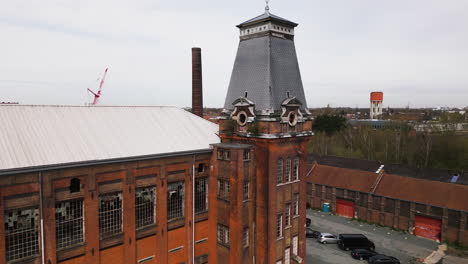 Decorated-tower-of-old-abandoned-commercial-building,-aerial-view