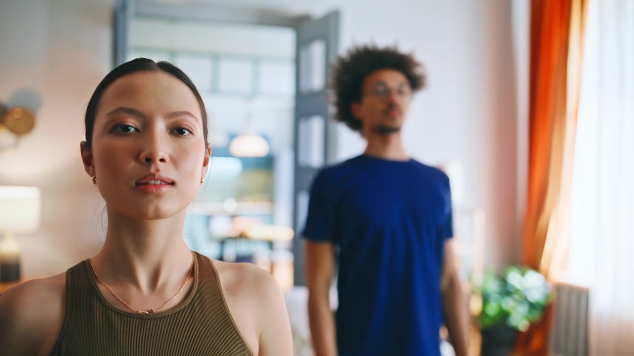Multiethnic couple practicing yoga breathing home closeup woman exhaling