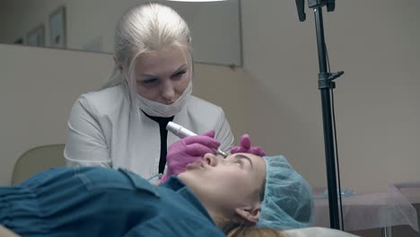 experienced woman in pink sterile gloves applies make-up