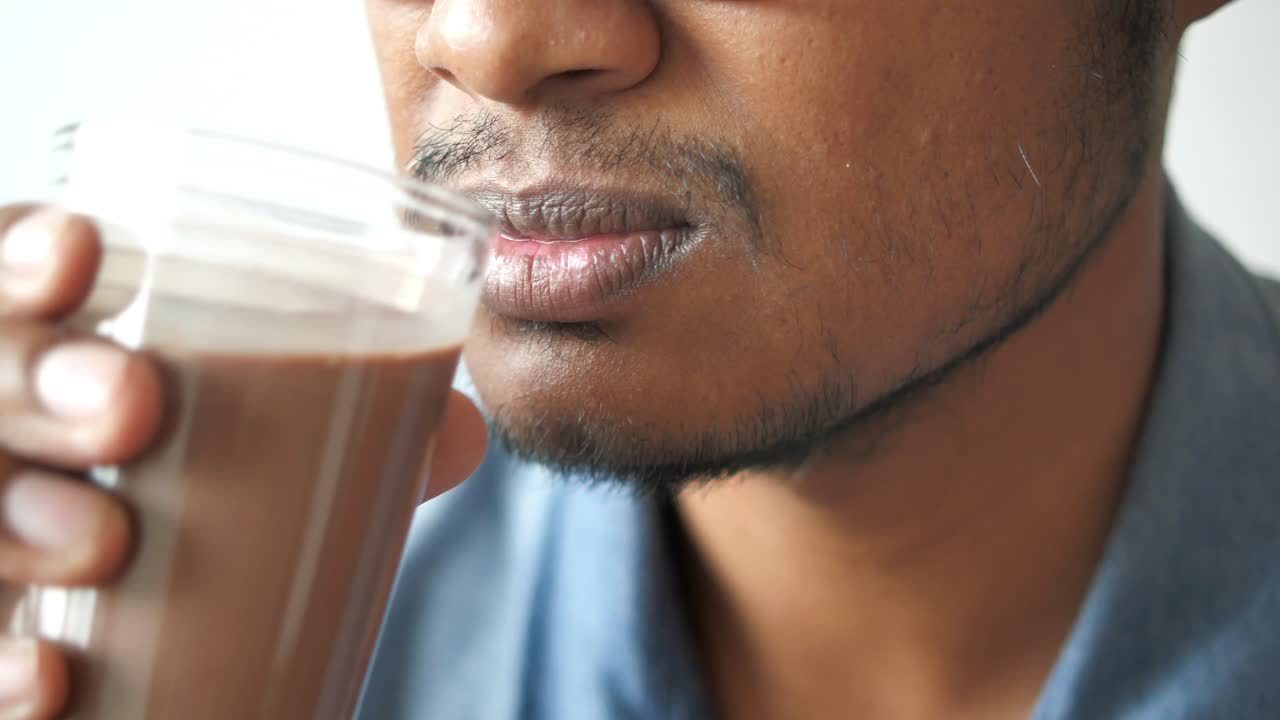 Closeup of person drinking chocolate milk