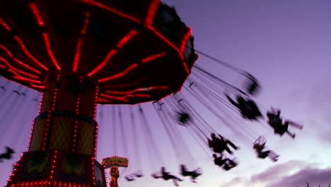 a merry go round spins with riders against the sky 1