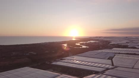 sunset view over coastal agricultural greenhouses