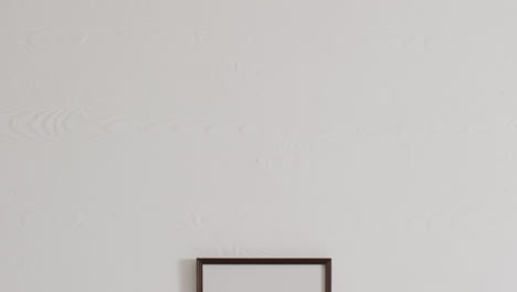 black frame with copy space on white background against white wall