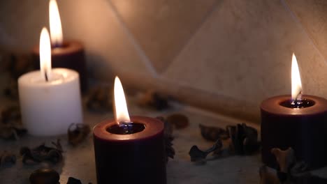 relaxing spa background with candles with flickering flame and some wooden petals