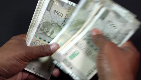 a man counting indian rupees