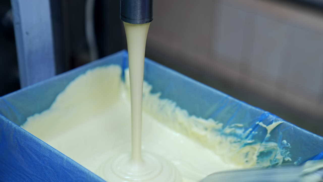 Butter in production line. Close up of butter industry process