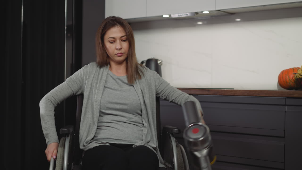 Young woman with muscular dystrophy cleans at home calmly