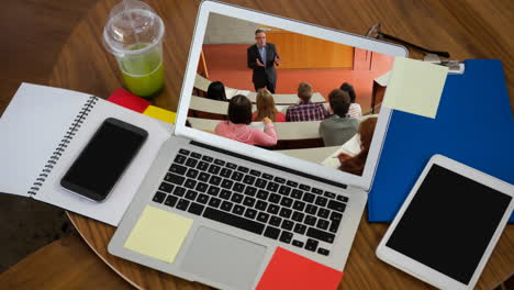 animation of a laptop showing multi-ethnic group of students on the screen