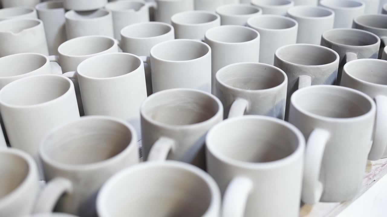 View of Rows of Unfinished Ceramic Mugs Arranged in a Pottery Factory