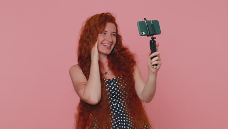 Girl-blogger-take-selfie-on-mobile-phone-selfie-stick-communicate-video-call-online-with-subscribers