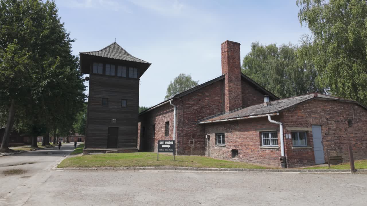 Auschwitz concentration camp in Poland with brick buildings and guard tower during a clear day
