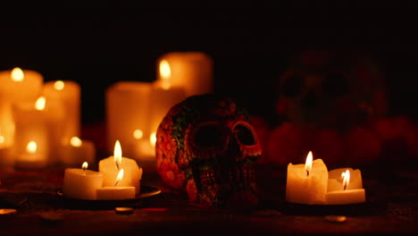 still life of decorated skull surrounded by candles celebrating mexican holiday of dia de muertos or day of the dead 2