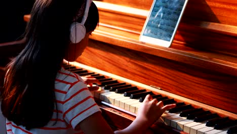 schoolgirl learning piano in music class 4k