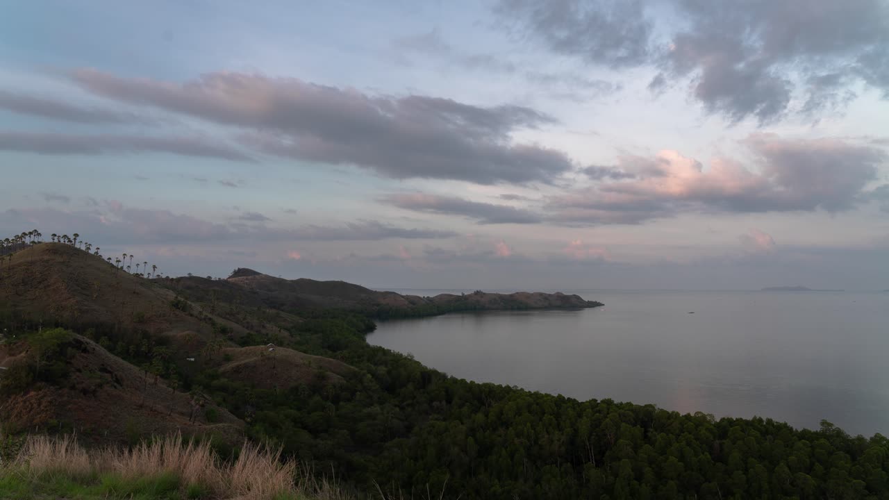 Scenic Coastal Landscape with Hills and Cloudy Sky at Dusk