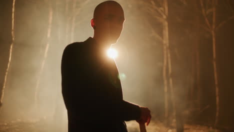 Man with Axe in a Dark Forest at Night