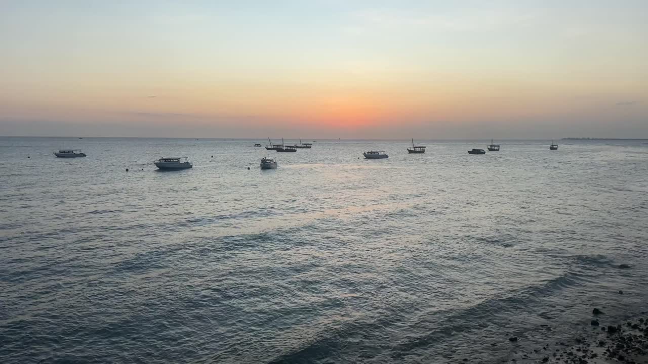 Boats ships at the harbour port in stone town zanzibar city tanzania sunset