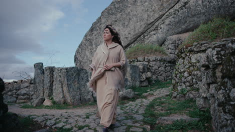 spiritual woman walking in a medieval village slow motion long shot