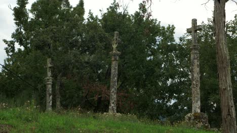 cross monument cruceiro in coles, galicia, surrounded by rural scenery, ourense