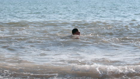 boy swimming in the ocean waves