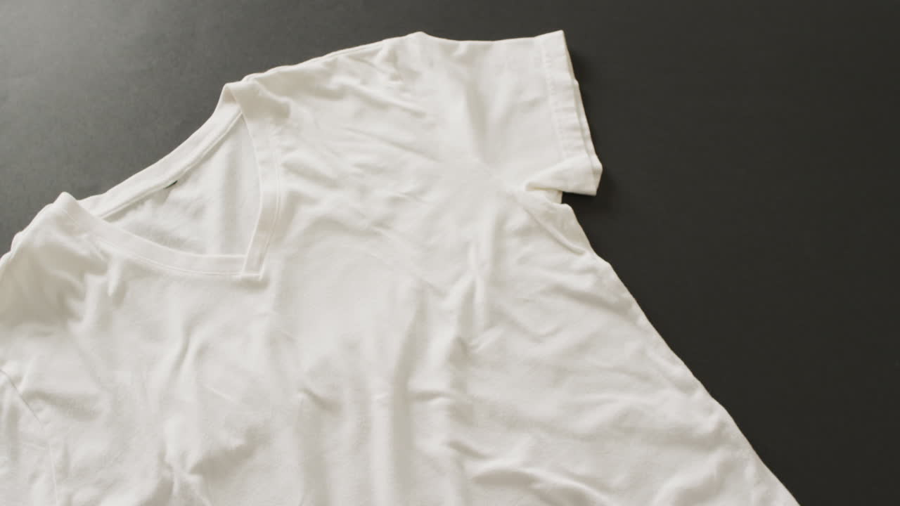 Video of close up of white t shirt on black background
