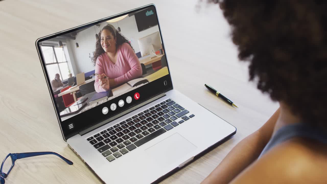 Animation of african american woman having video call on laptop