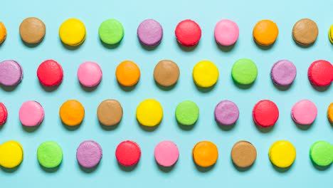 macarons in a row stop motion. multi-colored macaroons top view.