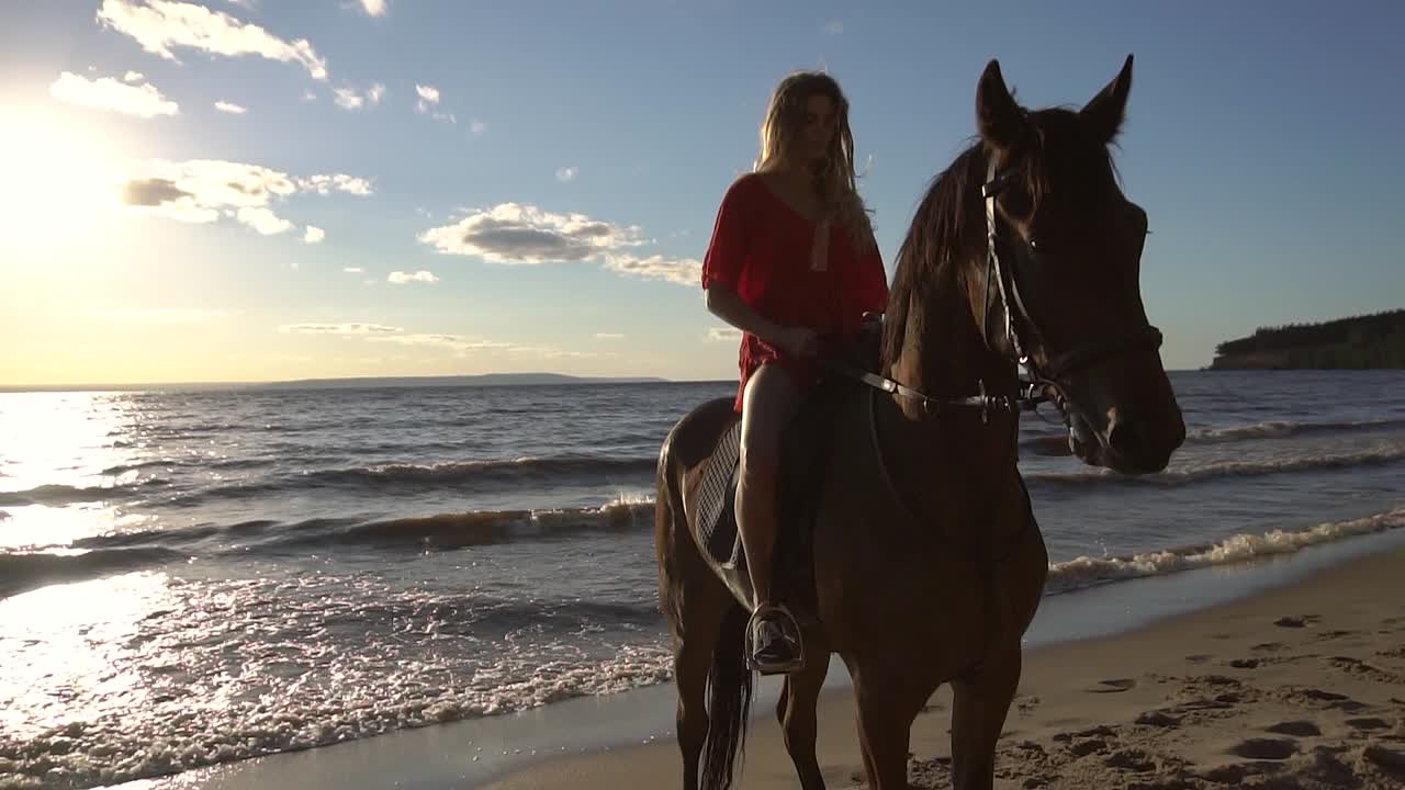 Woman Riding Horse at Sunset Beach