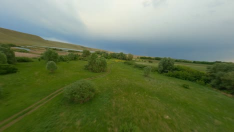 hiking trails lead through a green valley to the river. the concept of hiking in the picturesque area. a cloudy day, the sky is reflected on the surface of the water.