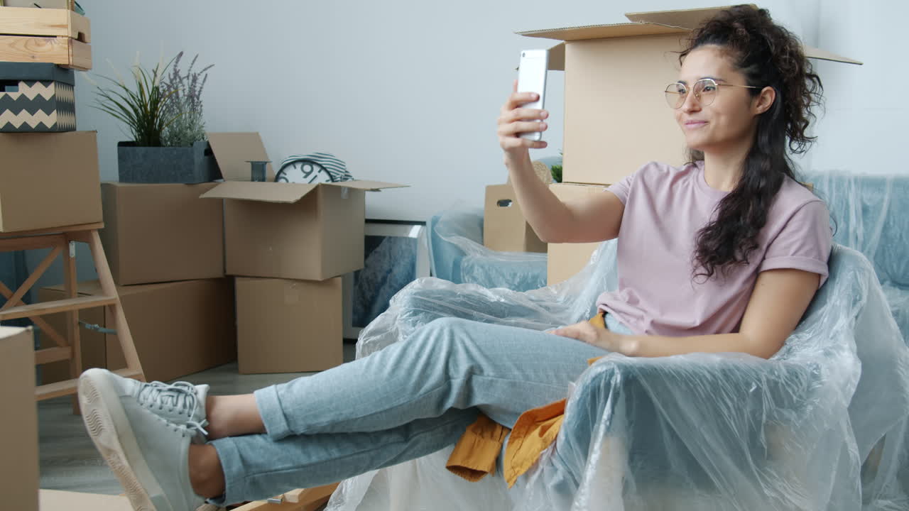 Woman Taking a Selfie During a Move