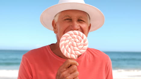 mature man eating a lollipop