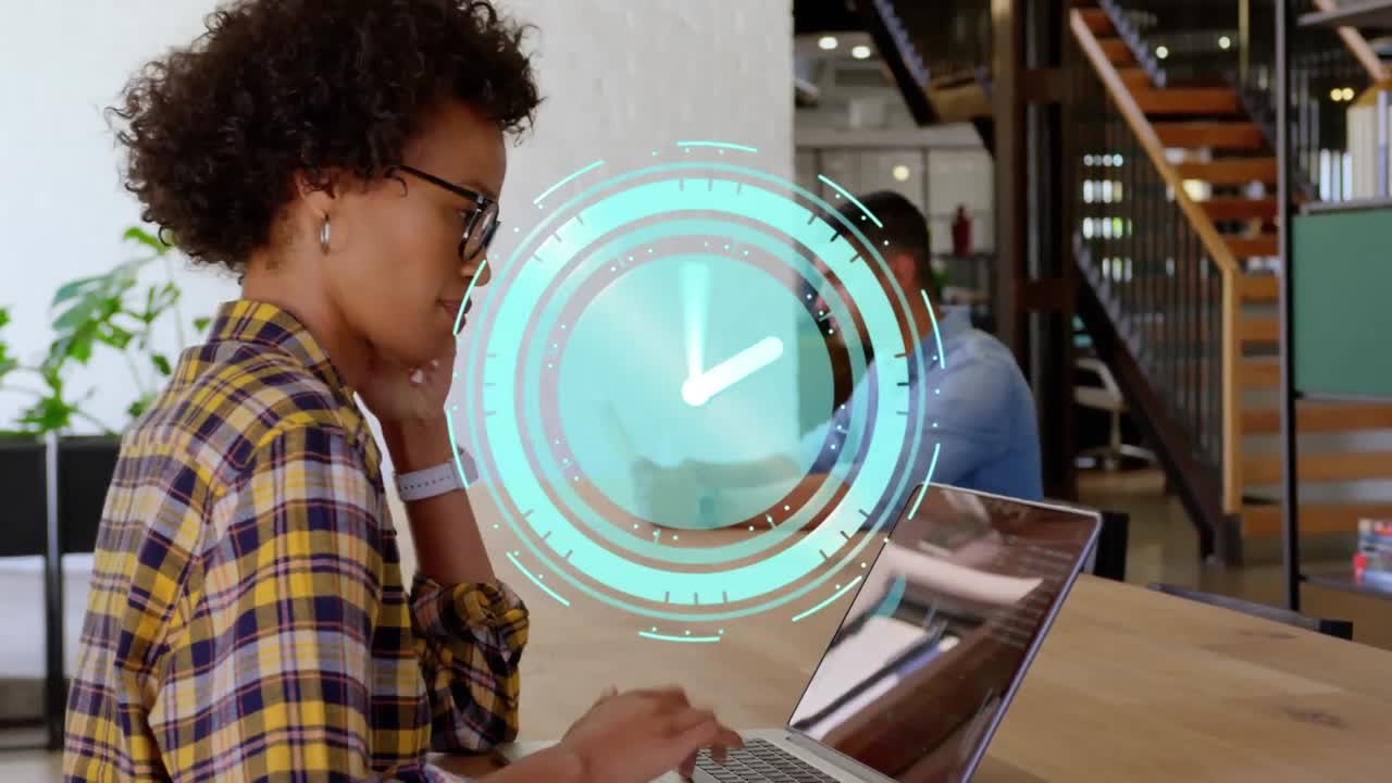 Animation of clock moving fast over businesswoman using laptop in office