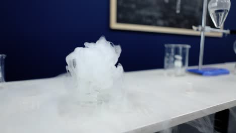 slow-motion capture of a beaker in a lab, releasing dense smoke bubbles in a captivating dance of science