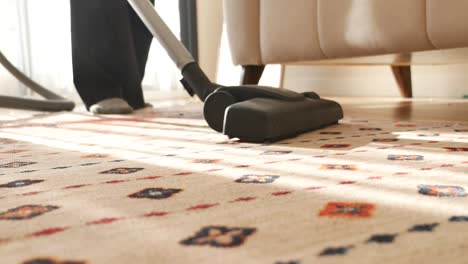 woman vacuuming the carpet in a living room