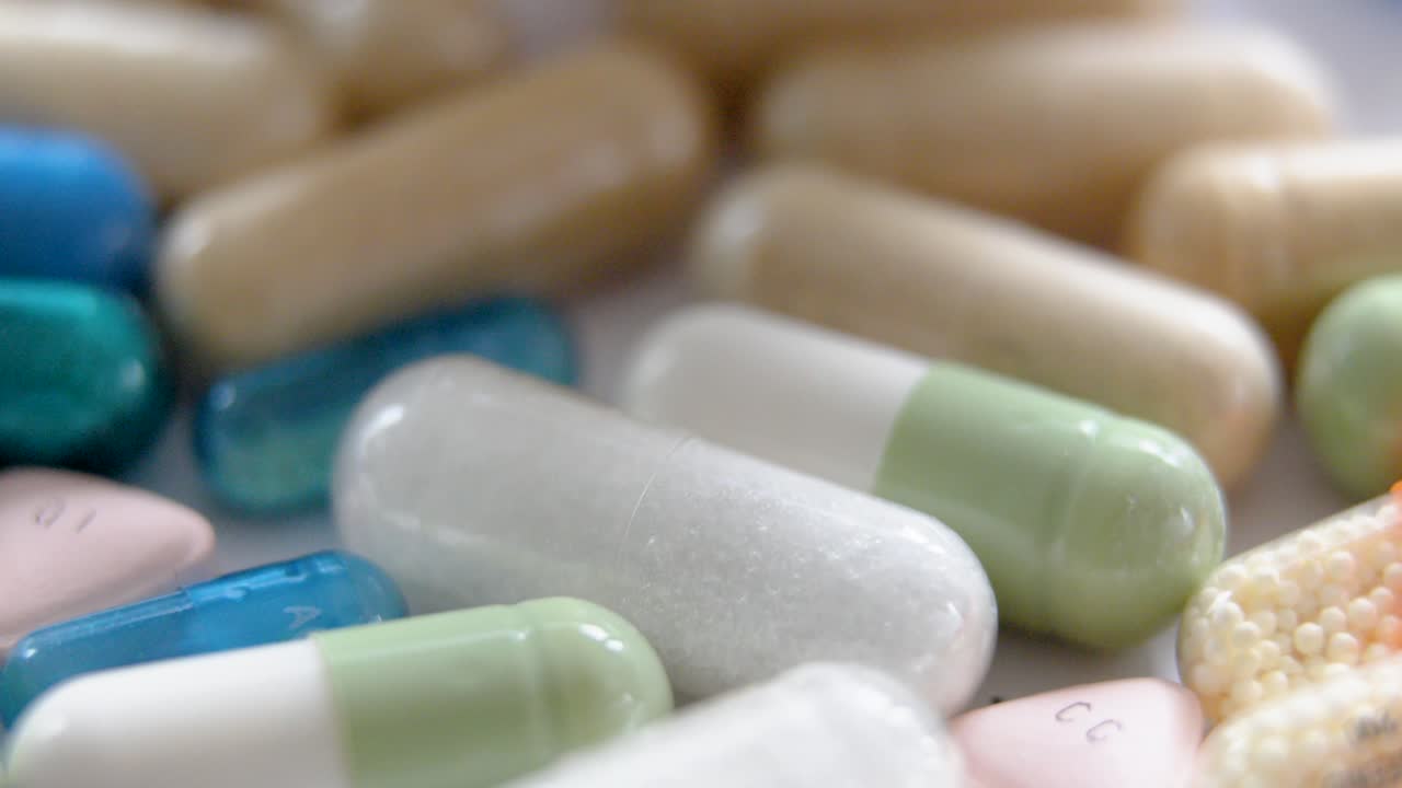 macro shot of assorted capsules with varied colors and textures under soft natural light