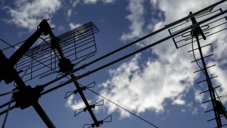 A timelapse of the sky and clouds with television aerials in the foreground