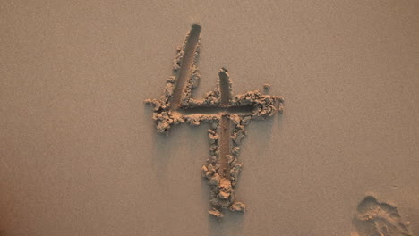 number four written in the sand and washed by a wave