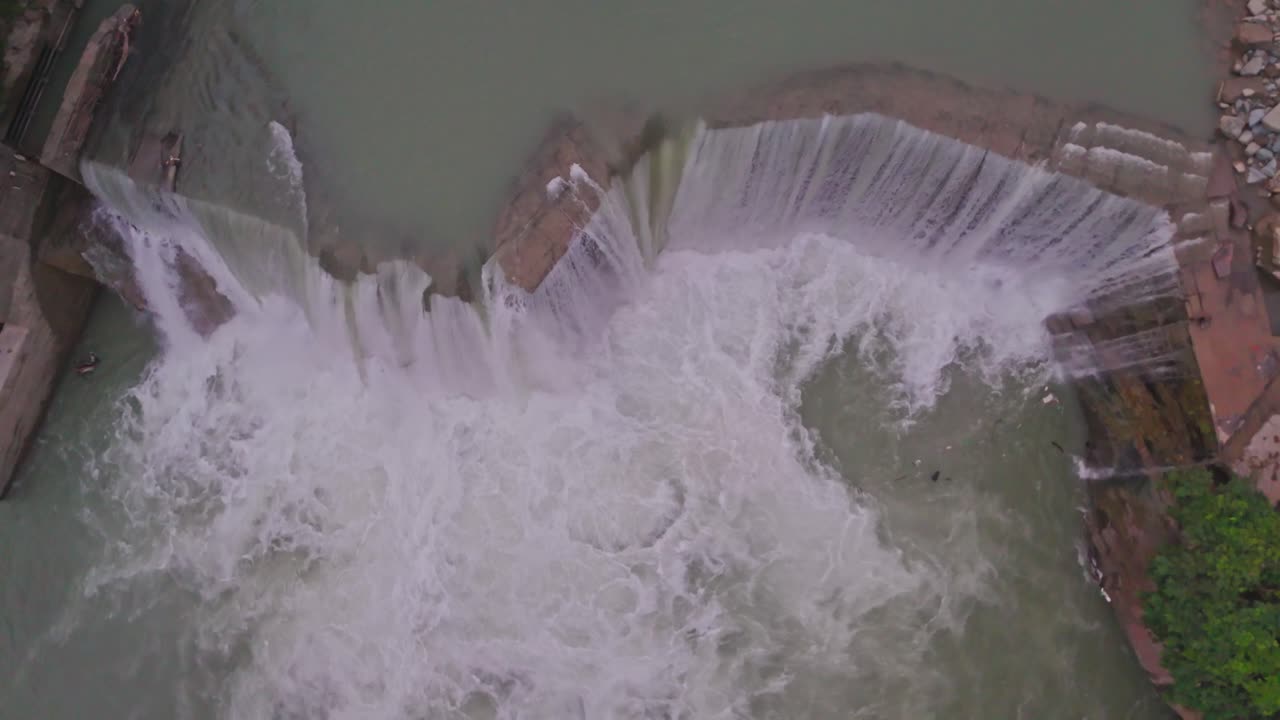 A breathtaking waterfall cascading between lush green mountains, showcasing the beauty of nature, flowing water, and the peaceful scenery of a pristine natural environment