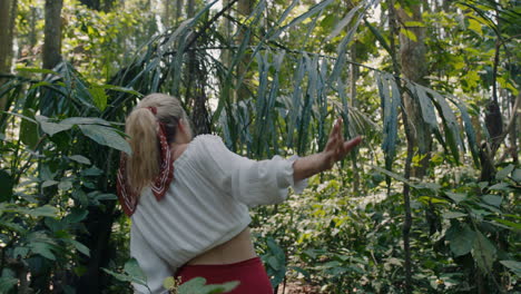 beautiful woman walking in forest exploring lush tropical rainforest alone enjoying beauty of nature lost on spiritual journey