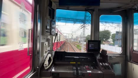 looking back view from a public train bound towards tokyo, japan on a cloudy day