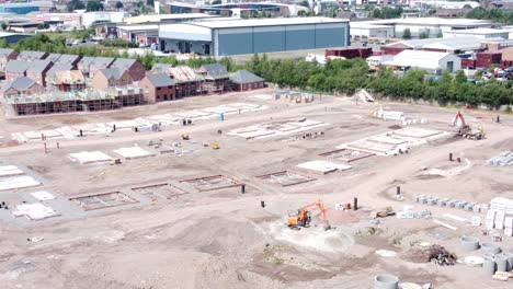 uk town housing development working foundation construction site aerial orbit right view