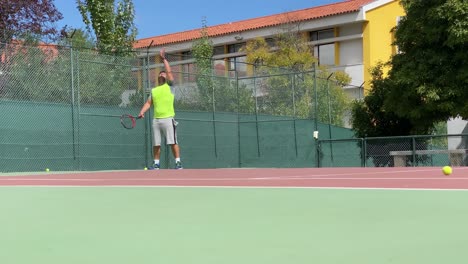 male tennis player servers by hitting ball with a racquet during championship match