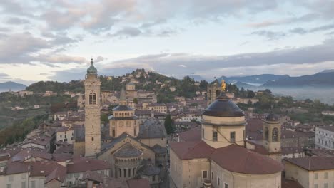 the bell towers of bergamo alta with flock of birds