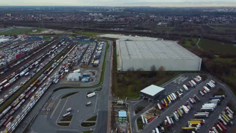 intermodal shipping terminal at industrial warehouse, drone view