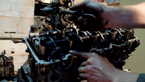 auto mechanic collects a renovated old car engine