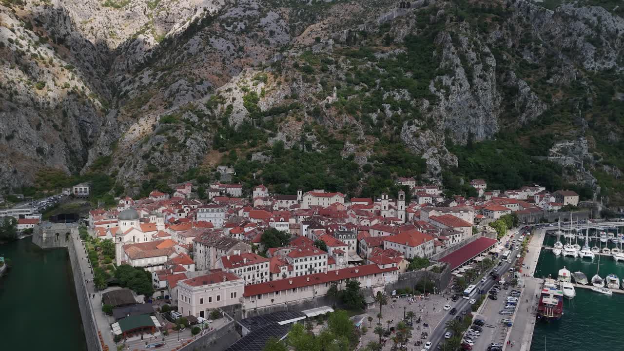 Aerial rise over cruise ship reveals old town of Kotor, Montenegro