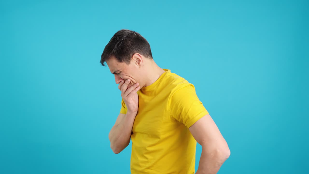 Man in yellow shirt thinking and upset
