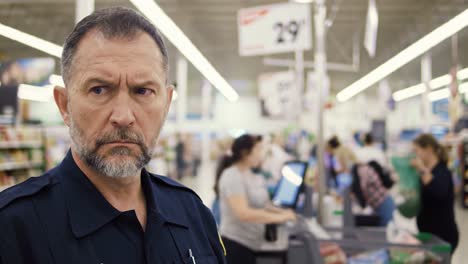 a close look at a security officer in a busy retail environment, observing customer interactions and activities amidst a crowded check-out area